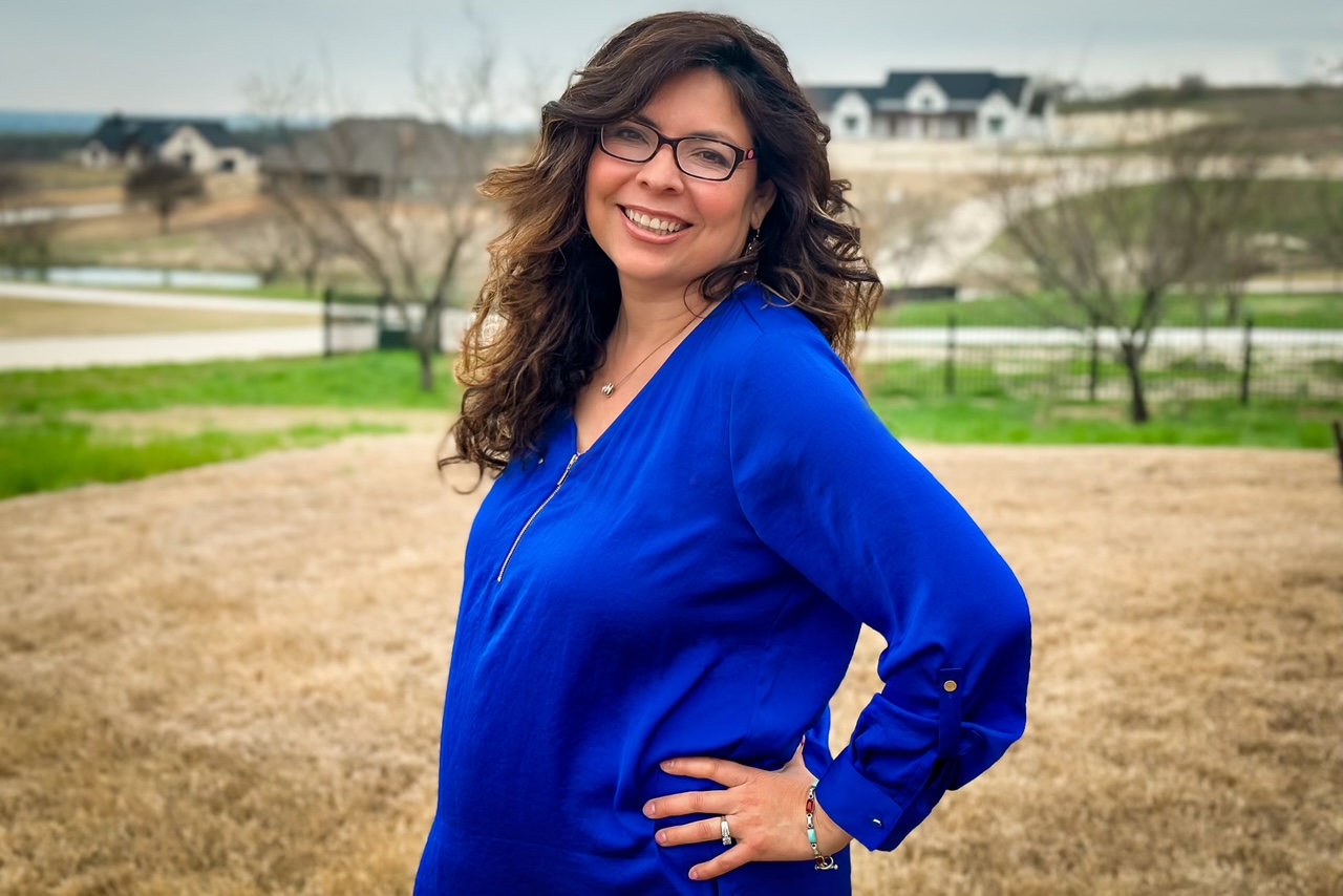Gabby Getzendanner, REALTOR® with Energy Realty Group, smiling outdoors in Parker County, serving home buyers and sellers in Aledo, Weatherford, and Fort Worth, Texas.